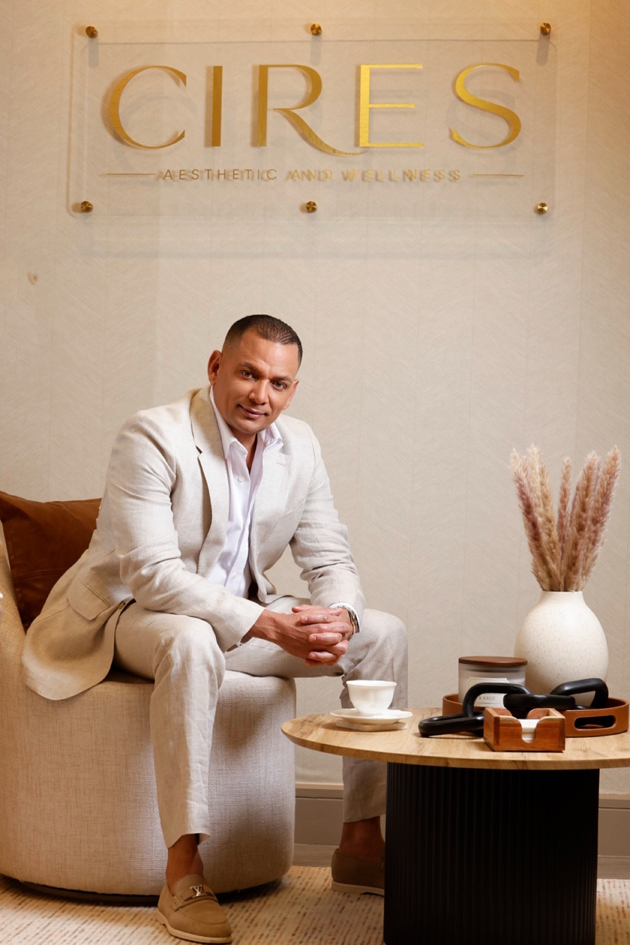Executive in a beige suit seated in an elegant office